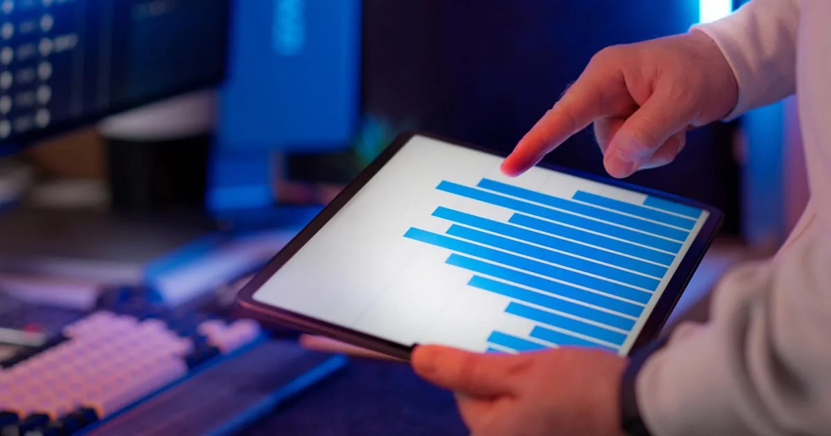 Marketer reviewing advertising results on a laptop, for a guide to cost per lead benchmarks by industry