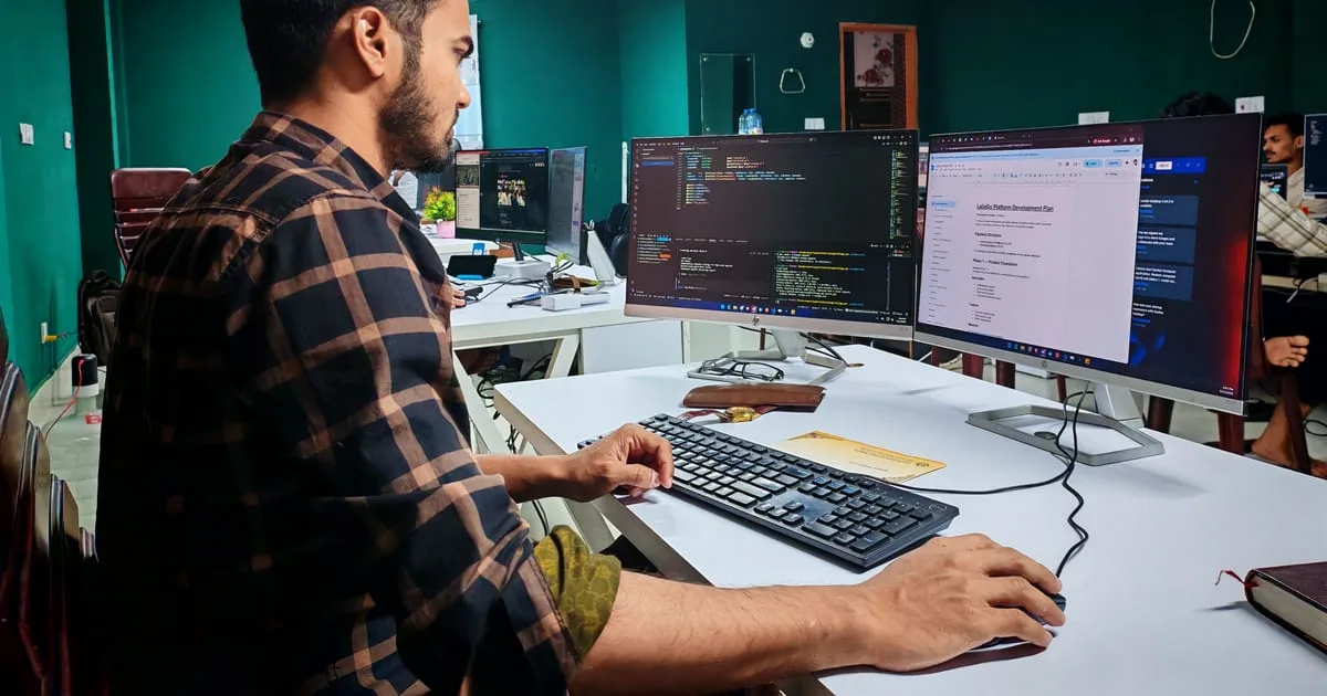 Developer at a desk building an online store's product page, with code on one monitor and the page preview on another