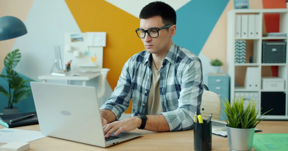 Marketer at a desk checking an email campaign on a laptop