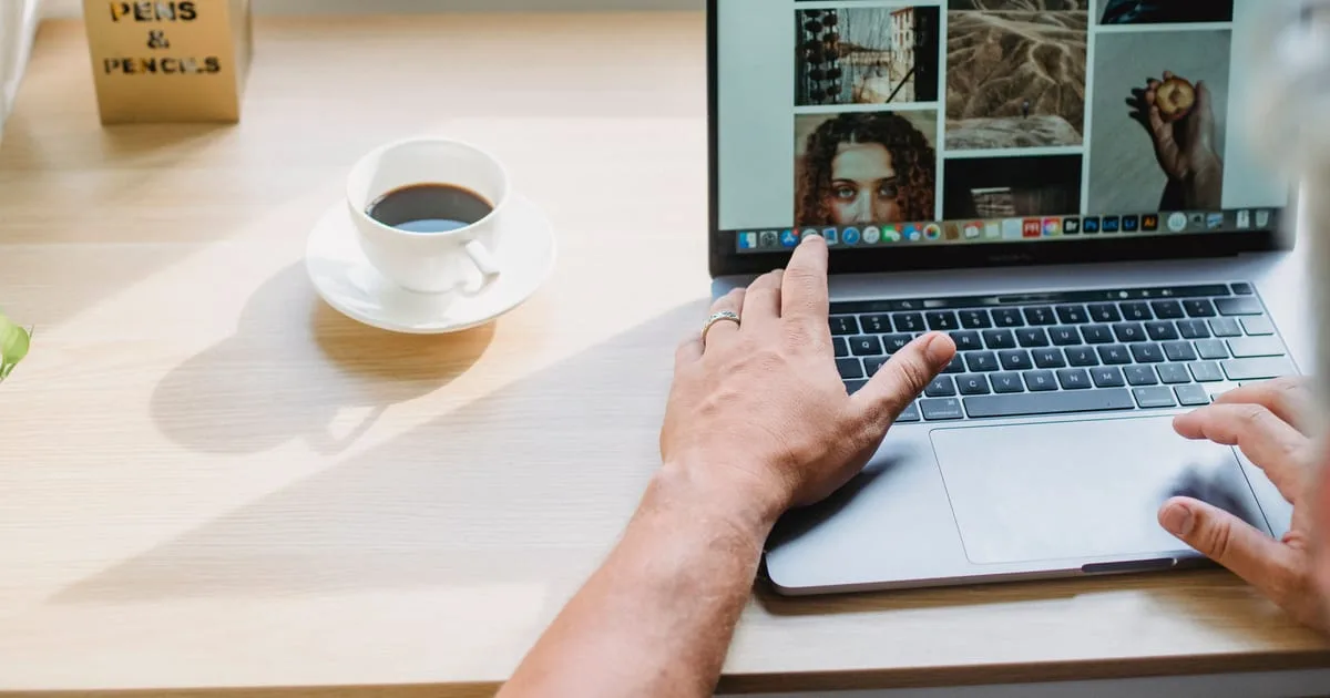 Web designer building a site on a laptop, for a comparison of two website platforms for small businesses