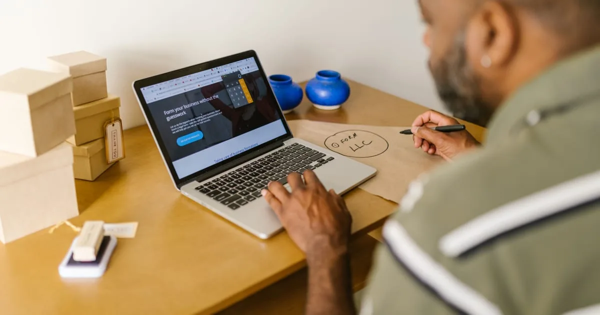 Small business owner reading search results on a laptop at an office desk