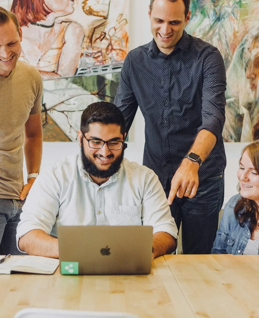 Team reviewing a project on a laptop